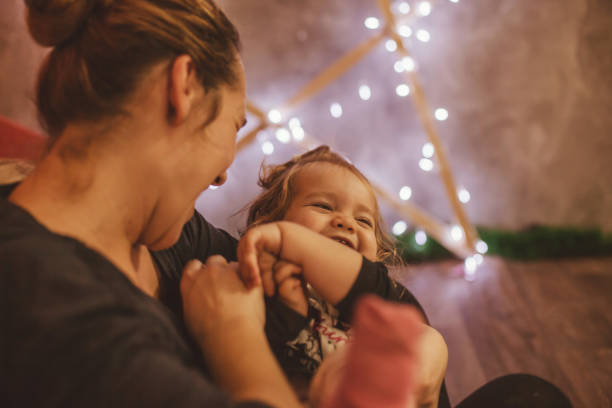 istock Mom tickling the baby 890668596