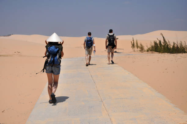 MUI NE, VIETNAM - MARCH 6, 2013: Tourists visiting the White sand Dunes near the South China sea in Vietnam