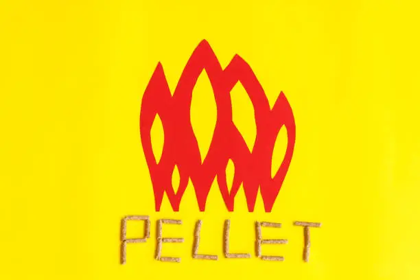 grains of pressed wood are laid at the base of red  flames to create united togheter  form the word pellet