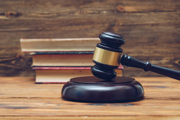 istock Gavel and law books on a wooden background 890686518