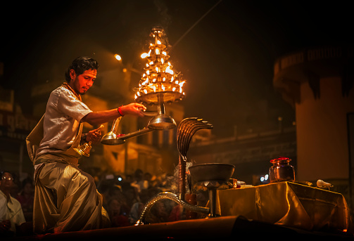 unknown priest performing ganga aarti in banaras on the banks of ganga on 21 march 2015