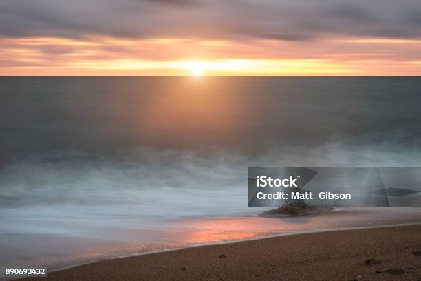 Beautiful Vibrant Sunset Landscape Image Of Burton Bradstock Golden Cliffs In Dorest England Stock Photo - Download Image Now