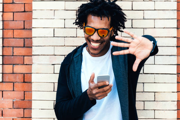 istock Portrait of afro handsome man using his mobile. 890698800