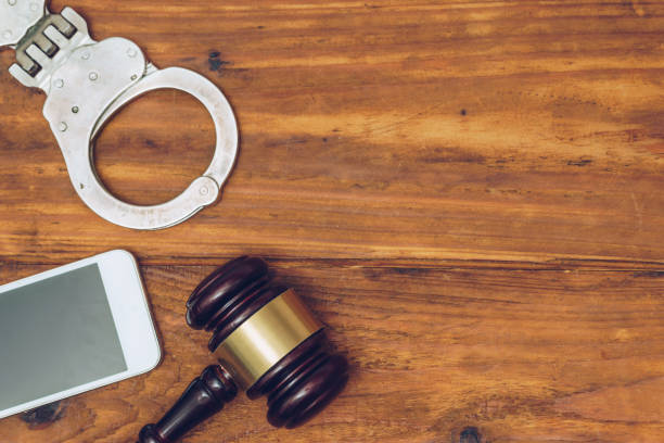 istock Judge gavel, handcuffs and smartphone, top view 890699190