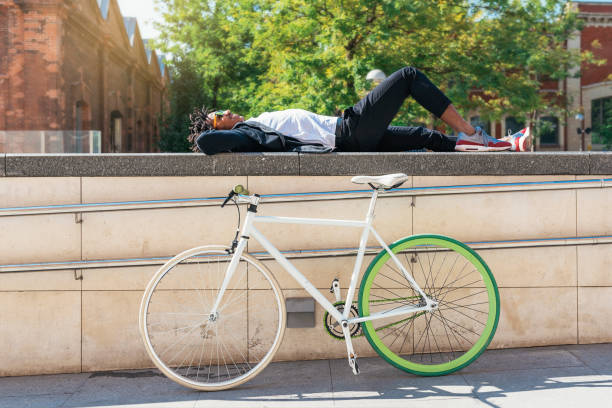 istock Handsome afro man relaxing near his bike. 890699282
