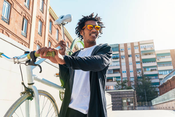istock Handsome afro man riding a bike. 890699672