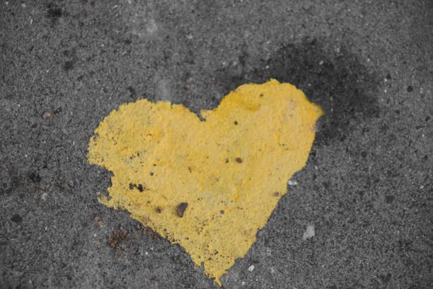 istock graffiti -Yellow heart on the sidewalk 890704130
