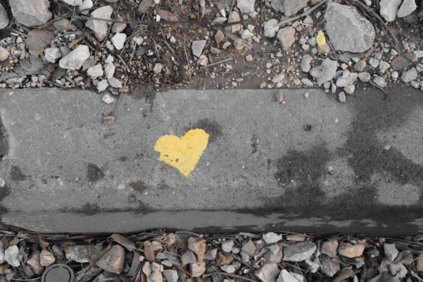 istock graffiti -Yellow heart on the sidewalk 890705790
