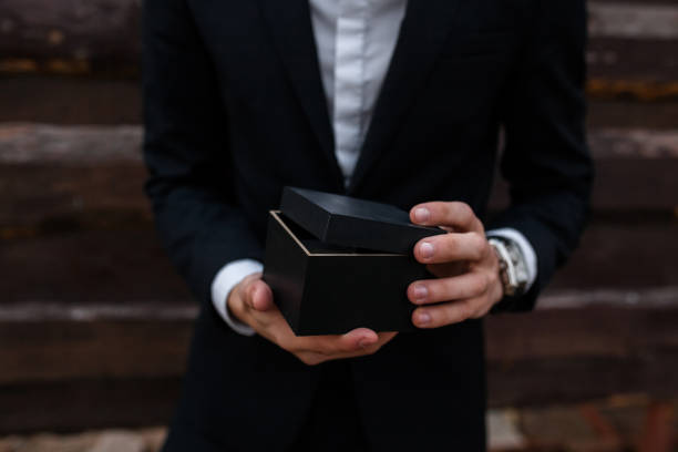 istock The guy holds in his hands a box, a gift or a product for sale. 890706588
