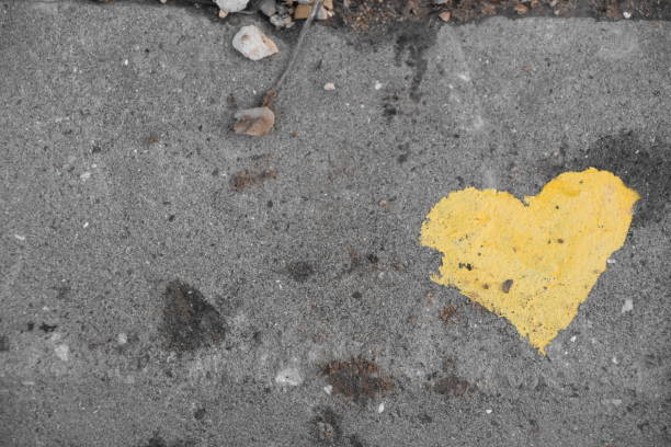 istock graffiti -Yellow heart on the sidewalk 890706688