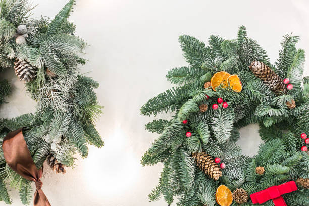 istock interior design, christmas, winter concept. fuzzy branches of conifer tree weaved into tidy circle with ribbons and bow, with red berries and pinecones, and even dried fruits 890724928