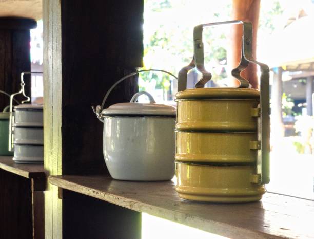 istock Yellow Tiffins And White Pot On Wooden Shelf 890736886