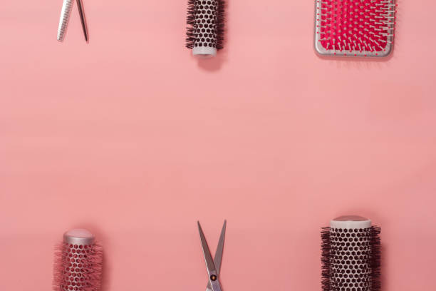 istock barber hairbrushes and scissors on a pink background 890740102