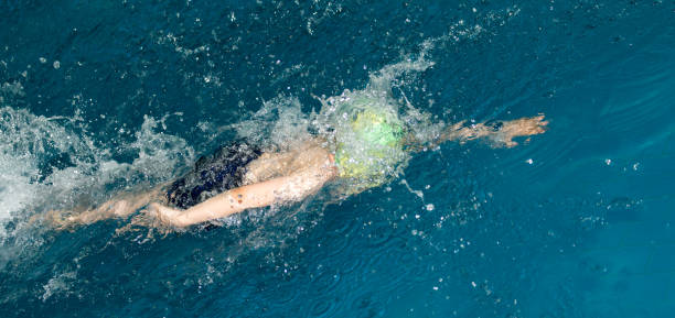 istock boy goes in for sports in the pool 890740904