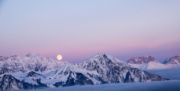 full moon rising over a winter dream landscape