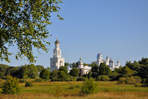 Branches of a birch on a background of Jurev monastery in the summer evening, Veliky Novgorod, Russia.