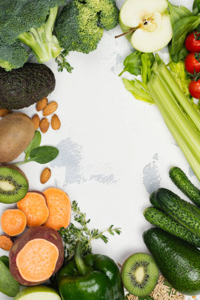 istock Green fruits and vegetables on white background 890745430
