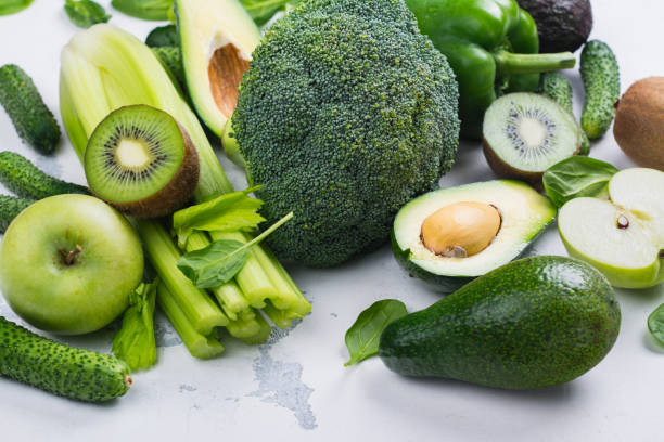 Green fruits and vegetables on white background Green fruits and vegetables on white background. Healthy vitamin eating or alkaline diet concept. Copy space folic acid stock pictures, royalty-free photos & images