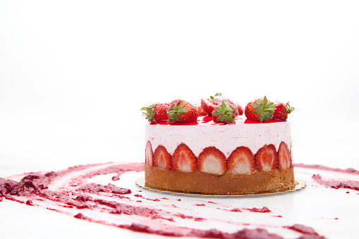 Strawberry Cake, eggs, flour and rolling pin isolated on white background.