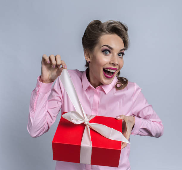istock Happy woman unpacks gift 890751908