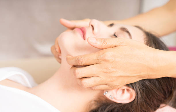 istock Woman is getting a face massage in spa 890759846
