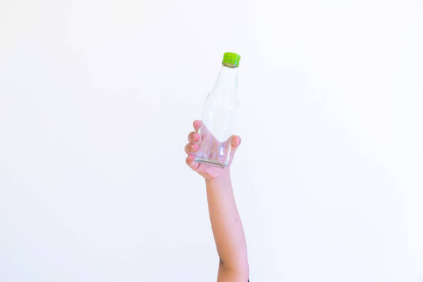 istock Hand hold show Recyclable plastic bottle a White background and paper cutter 890763546