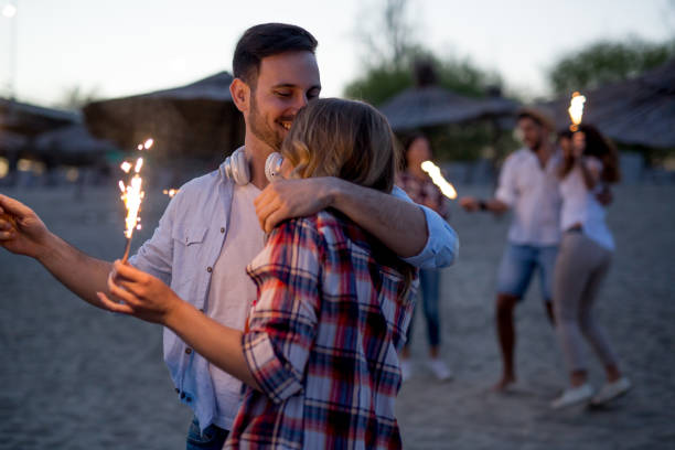 istock Group of happy friends having fun on beach at night 890763866
