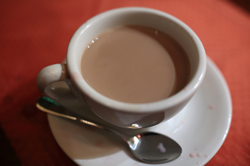 Cup with masala chai on a table