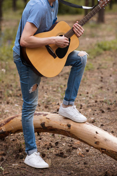 istock Talented guitarist playing forest hiking concept. 890768732