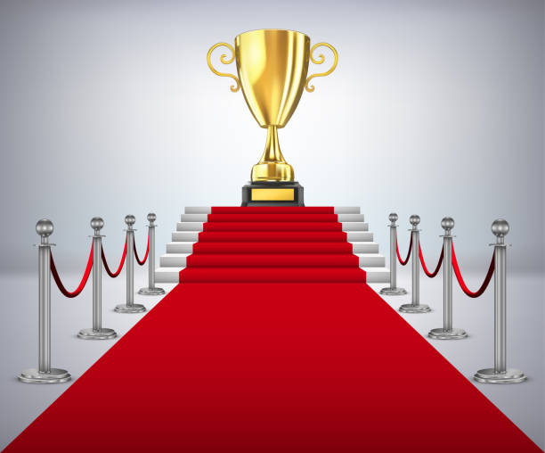 istock Gold cup of the winner on a red carpet path 890771266