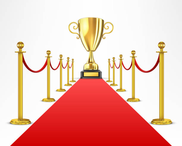 istock Gold cup of the winner on a red carpet path 890771392