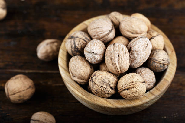 istock walnuts in a wooden plate on a wooden background 890771438