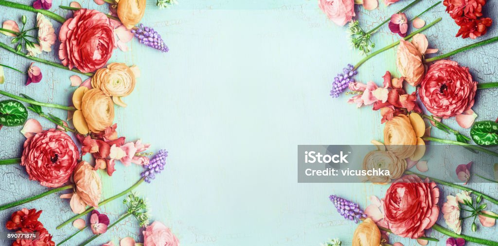 Pretty floral banner with various colorful garden flowers on blue turquoise shabby chic background Pretty floral banner with various colorful garden flowers on blue turquoise shabby chic background, top view Flower Stock Photo