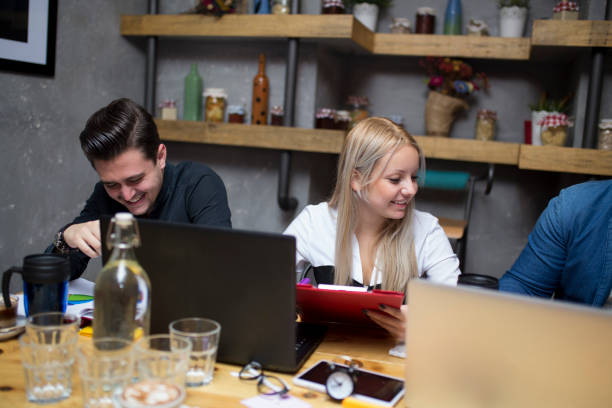 istock Three Businesspeople Working At Laptop In cafe 890771950