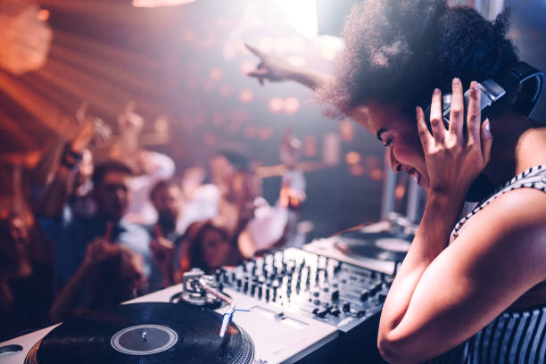 Feeling the music Young woman playing music at the club dj stock pictures, royalty-free photos & images