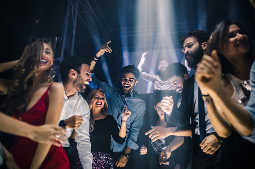 Group of friends dancing in the nightclub