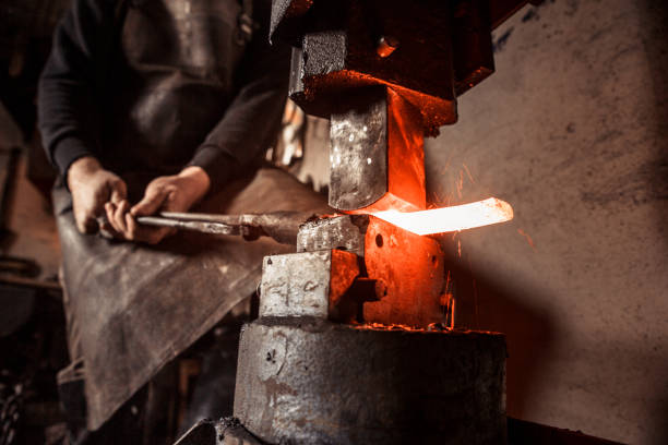 istock Blacksmith Shaping a Piece of Iron with Hydraulic Press Machine 890775206
