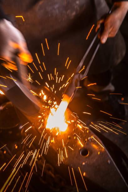 istock Hitting Molten Iron With a Hammer on Anvil, with Sparks Flying 890775224