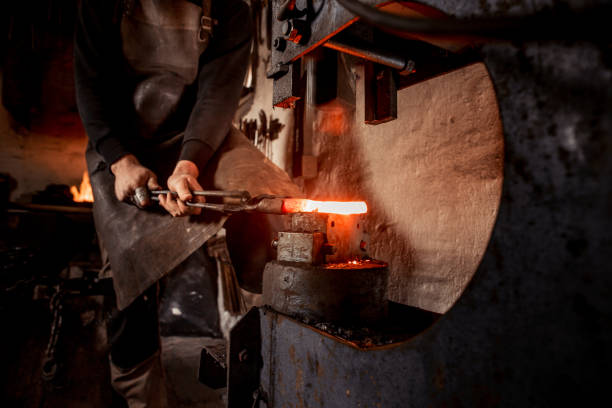 istock Blacksmith Shaping a Piece of Iron with Hydraulic Press Machine 890775248