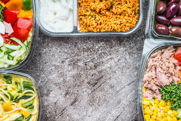 istock Various Healthy vegetables salad lunch boxes in plastic packages on gray stone background, top view 890778858