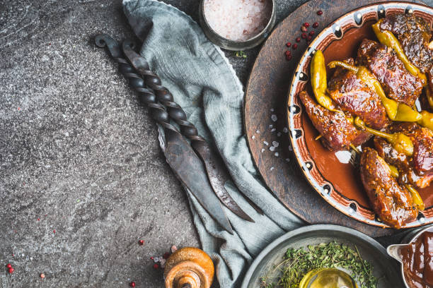 istock Spicy meat skewers with peperoni pepper on rustic kitchen table background, top view 890778952