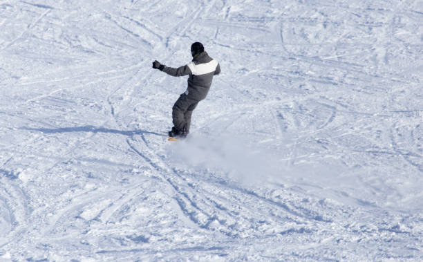 istock man snowboarding in the winter 890779606