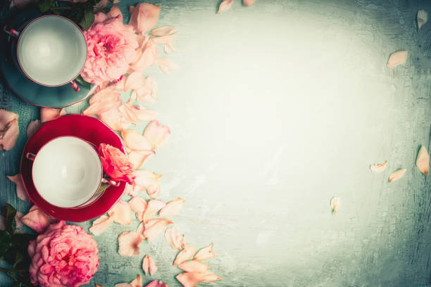 istock Roses with petals and cups on turquoise background, top view 890796696