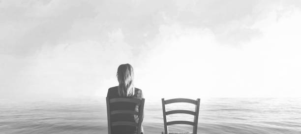 alone woman sitting next to her lover's empty chair