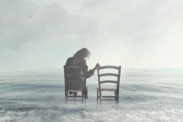 istock sad woman looks nostalgically at her lover's empty chair 890797114