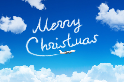 Happy Merry Christmas concept. Drawing by airplane vapor contrail in sky