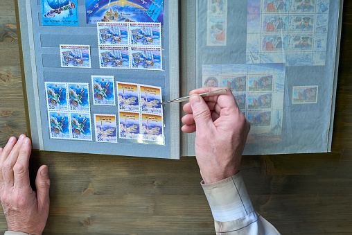 Senior Man collecting stamps from around the world