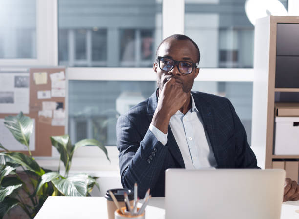 istock Thoughtful businessman is working in office 890837300
