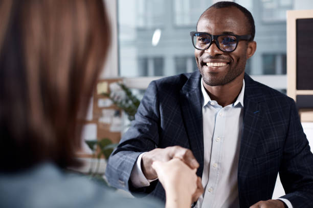 optimistic qualified man is interviewing lady - gesturing interview business sitting imagens e fotografias de stock