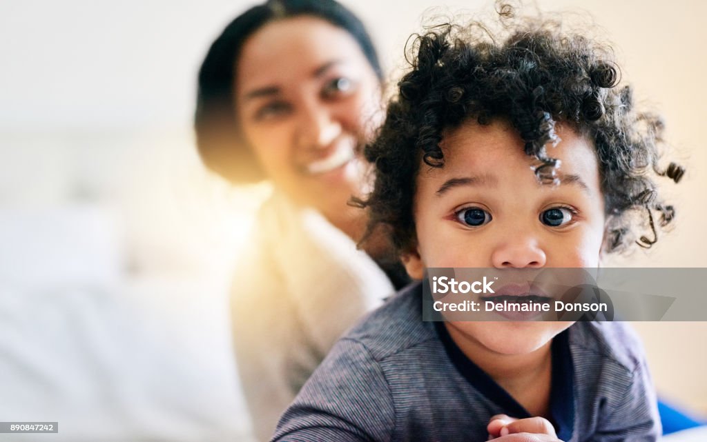 Little wonderer Shot of a mother bonding with her baby boy at home Adult Stock Photo